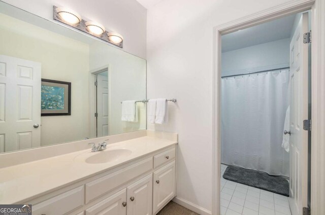 626 Kimberly Ln NE, Atlanta, GA 30306 - bathroom featuring vanity, tile patterned flooring, baseboards, and a shower with shower curtain