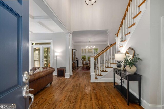 626 Kimberly Ln NE, Atlanta, GA 30306 - foyer entrance with stairs, wood finished floors, a chandelier, baseboards, and crown molding