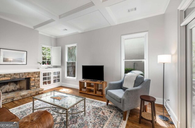 626 Kimberly Ln NE, Atlanta, GA 30306 - living room with coffered ceiling, wood finished floors, baseboards, beam ceiling, and a stone fireplace