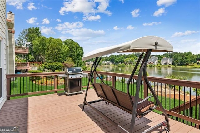 wooden terrace with grilling area and a water view