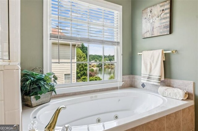 full bathroom featuring plenty of natural light and a tub with jets
