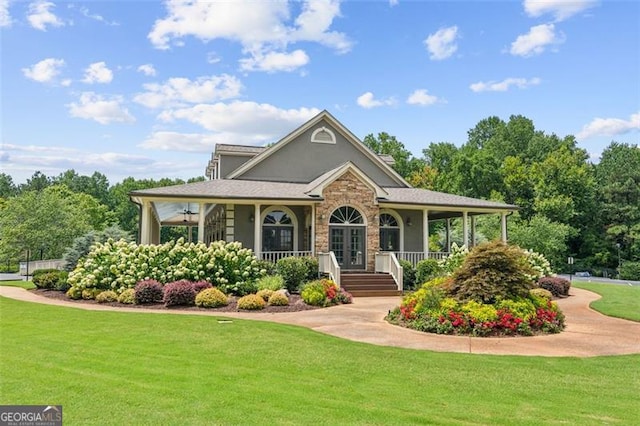 farmhouse-style home with a porch, a front lawn, and stucco siding
