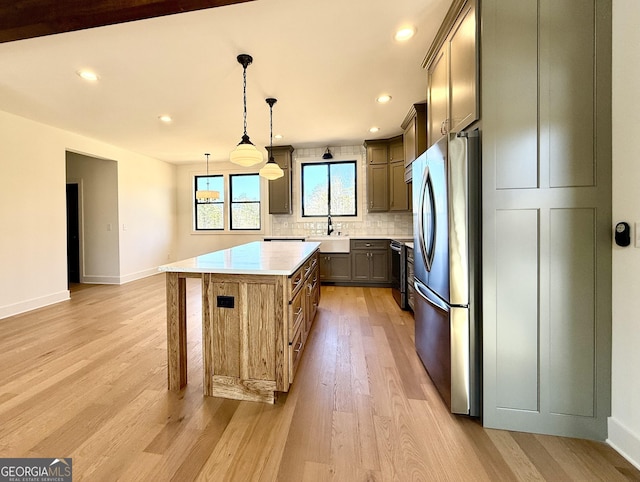 116 Boulder Ln, Cleveland, GA 30528 - kitchen featuring stainless steel appliances, tasteful backsplash, a center island, baseboards, and light wood-style floors