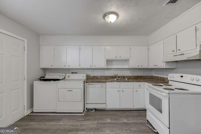 kitchen featuring white appliances, washing machine and clothes dryer, under cabinet range hood, a sink, and white cabinets