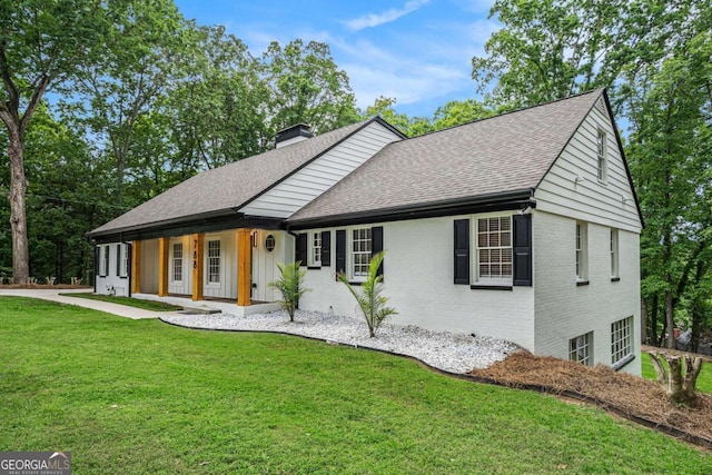 788 Sherwood Rd, Gainesville, GA 30501 - view of front of house featuring covered porch, a chimney, roof with shingles, brick siding, and a front lawn