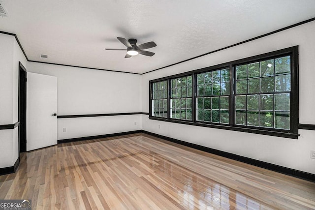 788 Sherwood Rd, Gainesville, GA 30501 - empty room with ceiling fan, plenty of natural light, wood finished floors, baseboards, and crown molding