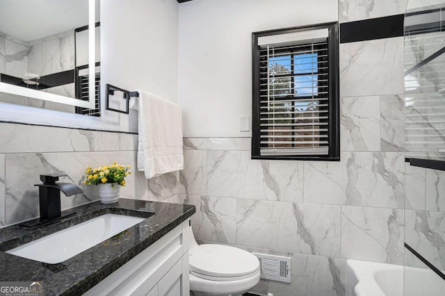 788 Sherwood Rd, Gainesville, GA 30501 - bathroom featuring tile walls, toilet, a bathtub, and vanity
