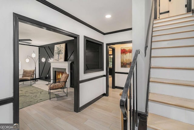 788 Sherwood Rd, Gainesville, GA 30501 - staircase with wood finished floors, crown molding, a warm lit fireplace, and recessed lighting