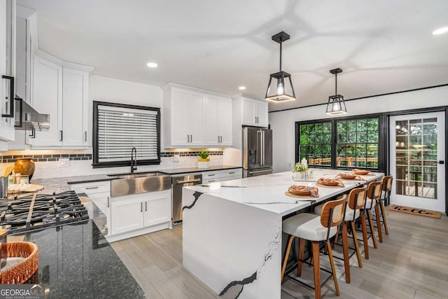 788 Sherwood Rd, Gainesville, GA 30501 - kitchen with stainless steel appliances, a sink, white cabinets, a kitchen island, and recessed lighting