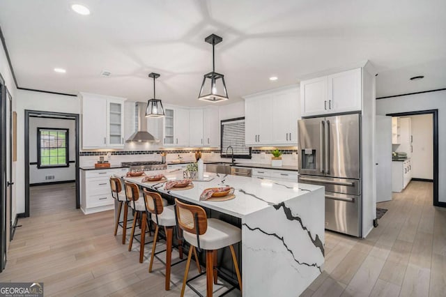 788 Sherwood Rd, Gainesville, GA 30501 - kitchen with stainless steel fridge with ice dispenser, wall chimney range hood, backsplash, white cabinets, and light wood-style flooring