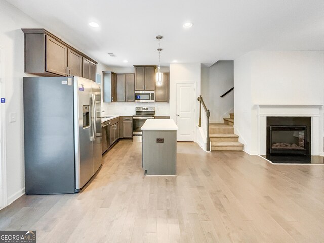 4922 Longview Walk, Decatur, GA 30035 - kitchen featuring stainless steel appliances, a kitchen island, light wood-type flooring, recessed lighting, and light countertops