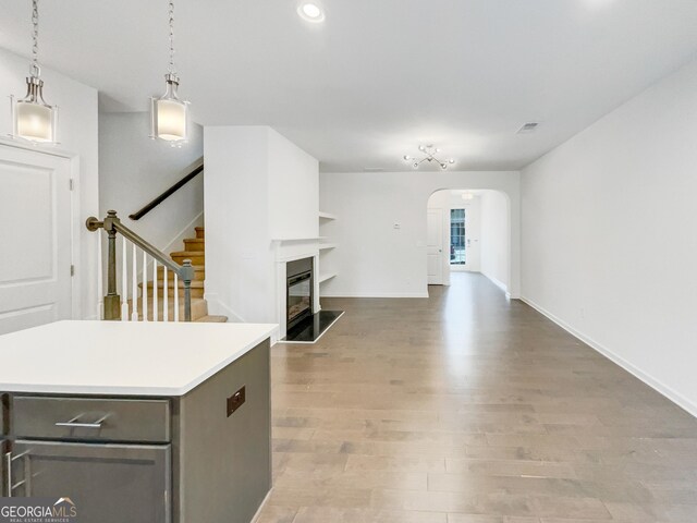 4922 Longview Walk, Decatur, GA 30035 - unfurnished living room featuring arched walkways, light wood-type flooring, stairway, a glass covered fireplace, and recessed lighting