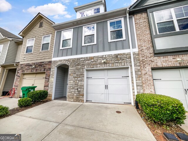 4922 Longview Walk, Decatur, GA 30035 - view of property with concrete driveway, a garage, board and batten siding, and stone siding