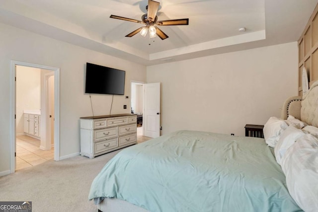 2046 Yvette Way, Braselton, GA 30517 - bedroom with a raised ceiling, light colored carpet, baseboards, ensuite bathroom, and ceiling fan