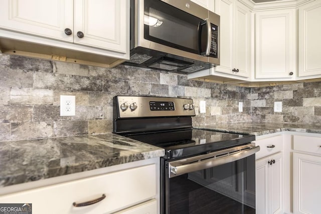 kitchen featuring stainless steel appliances, backsplash, and white cabinetry