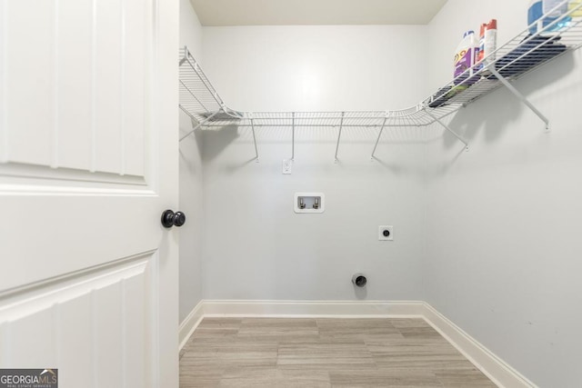 laundry room featuring washer hookup, electric dryer hookup, baseboards, and light wood-type flooring