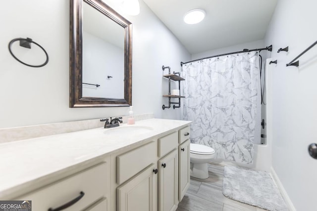 full bath featuring vanity, toilet, and shower / tub combo
