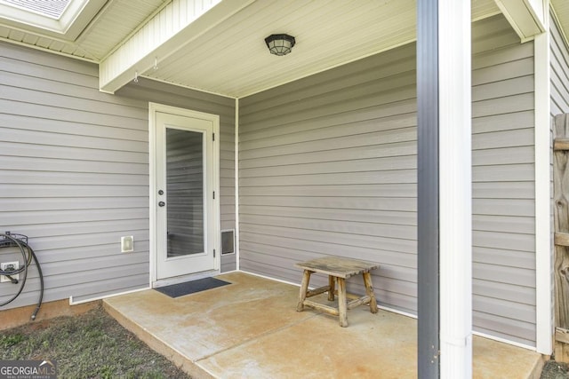 property entrance featuring a patio area