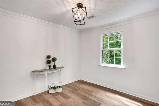 4368 Heritage Glen Ct, Marietta, GA 30068 - unfurnished room with a chandelier, baseboards, wood finished floors, crown molding, and a textured ceiling