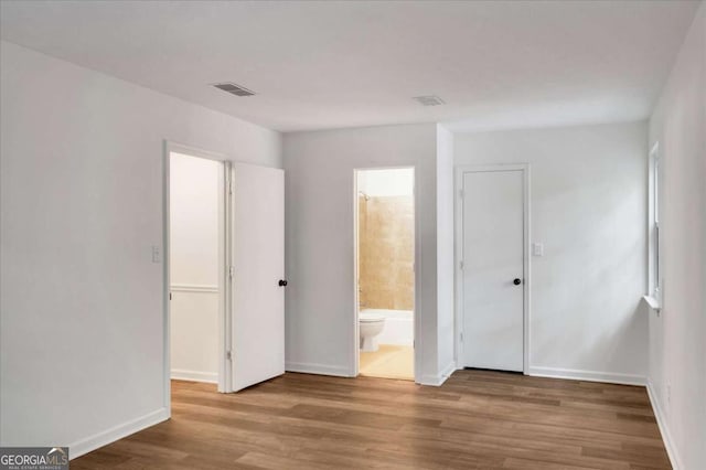 4368 Heritage Glen Ct, Marietta, GA 30068 - unfurnished bedroom featuring wood finished floors, baseboards, and ensuite bathroom