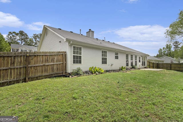 back of property featuring a chimney and a patio
