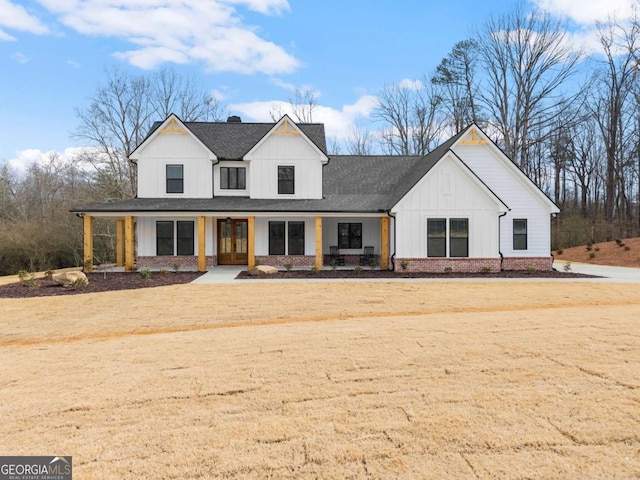 1087 Webb W Rd, Cleveland, GA 30528 - modern farmhouse style home featuring board and batten siding, roof with shingles, covered porch, and french doors
