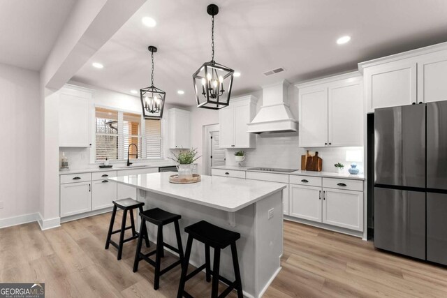 1087 Webb W Rd, Cleveland, GA 30528 - kitchen with freestanding refrigerator, premium range hood, black electric stovetop, recessed lighting, and a chandelier