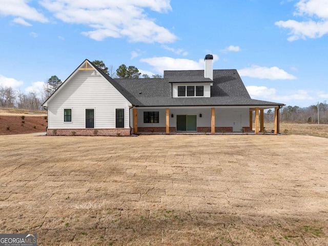 1087 Webb W Rd, Cleveland, GA 30528 - rear view of house featuring a chimney, brick siding, a shingled roof, and covered porch