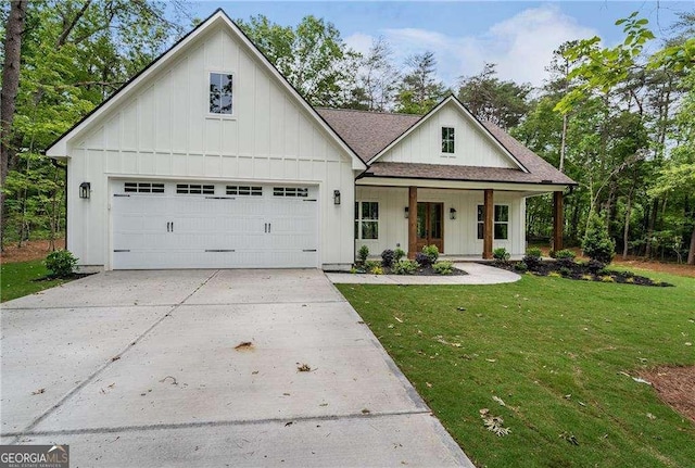 modern inspired farmhouse featuring board and batten siding, a front yard, driveway, covered porch, and a shingled roof