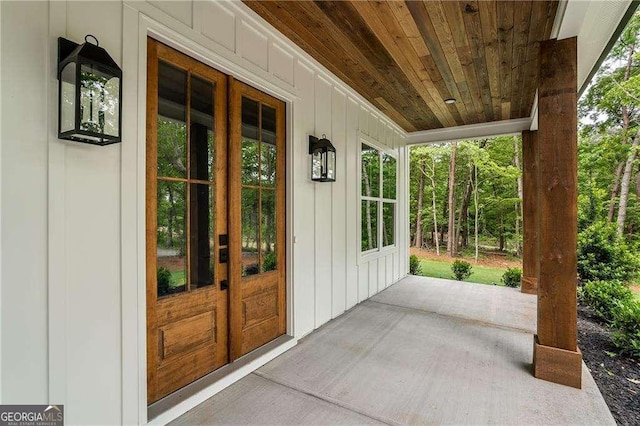 property entrance featuring board and batten siding and a porch
