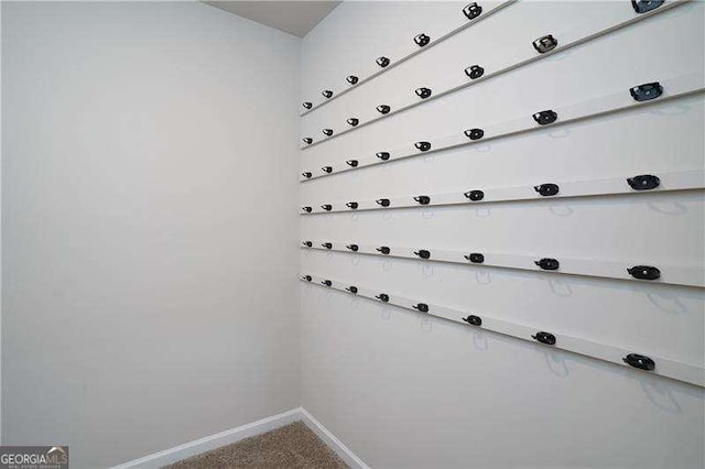 laundry area featuring baseboards and carpet