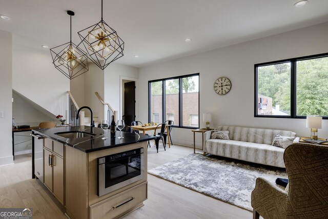 1968 8th St, Chamblee, GA 30341 - kitchen with stainless steel microwave, open floor plan, light wood-style floors, a chandelier, and recessed lighting