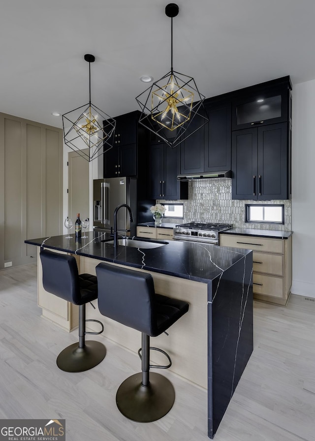 1968 8th St, Chamblee, GA 30341 - kitchen with stainless steel appliances, a chandelier, a sink, decorative backsplash, and light wood-style floors