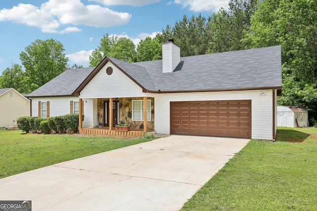 view of front of house featuring covered porch, an attached garage, a front yard, a chimney, and driveway