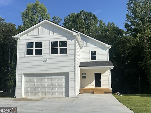 113 Sidetrack Cir, Comer, GA 30629 - view of front of house with board and batten siding, an attached garage, and driveway