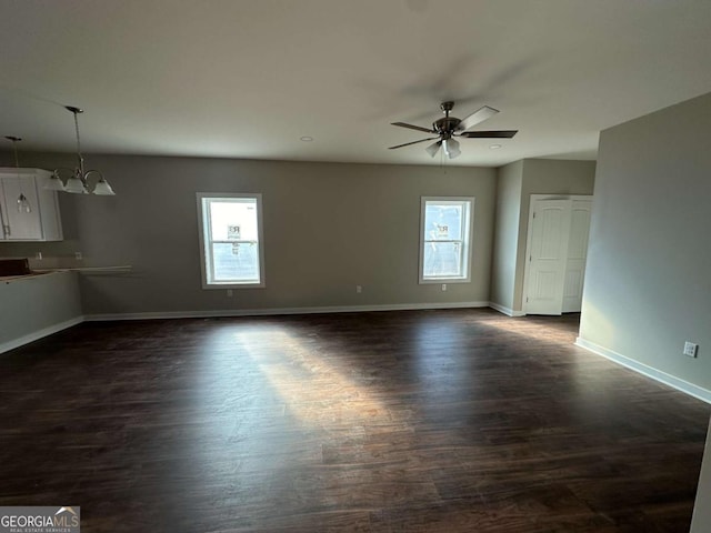 113 Sidetrack Cir, Comer, GA 30629 - unfurnished living room featuring plenty of natural light, a ceiling fan, dark wood-type flooring, and baseboards