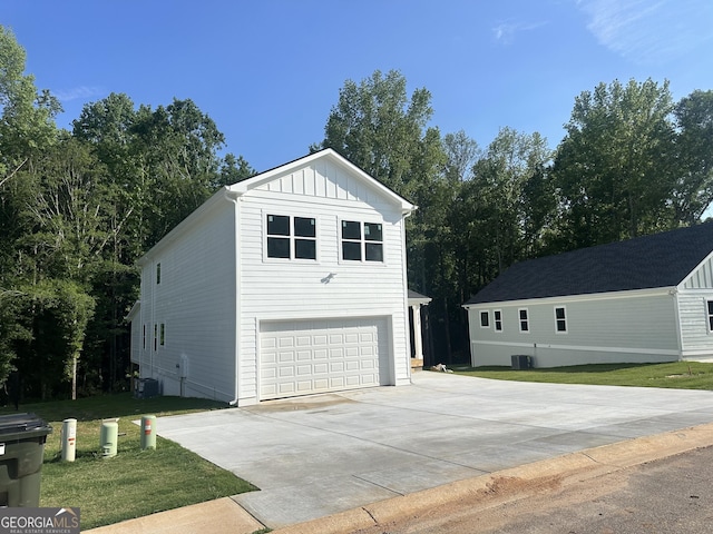 113 Sidetrack Cir, Comer, GA 30629 - view of property exterior with a garage, board and batten siding, concrete driveway, a yard, and central AC unit
