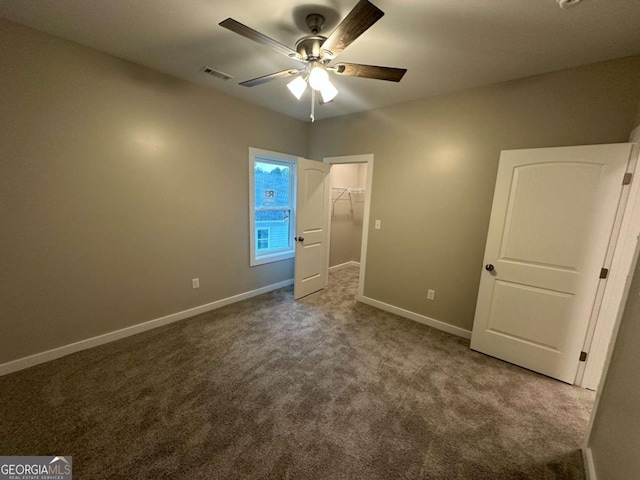 113 Sidetrack Cir, Comer, GA 30629 - unfurnished bedroom featuring dark colored carpet, baseboards, a spacious closet, ceiling fan, and a closet