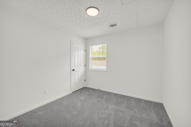 1645 Cobbs Creek Ln, Decatur, GA 30032 - empty room featuring attic access, a textured ceiling, dark colored carpet, and baseboards