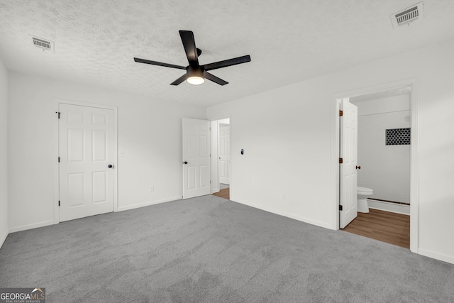 1645 Cobbs Creek Ln, Decatur, GA 30032 - unfurnished bedroom with carpet flooring, baseboards, connected bathroom, and a textured ceiling