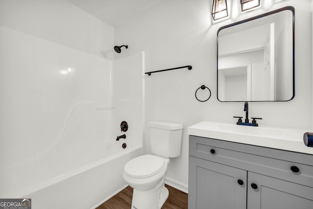 1645 Cobbs Creek Ln, Decatur, GA 30032 - bathroom with wood finished floors, toilet, vanity, baseboards, and washtub / shower combination