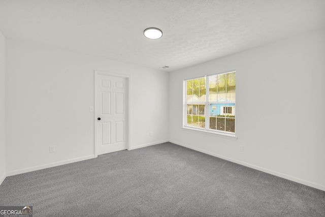 1645 Cobbs Creek Ln, Decatur, GA 30032 - empty room featuring dark colored carpet and baseboards