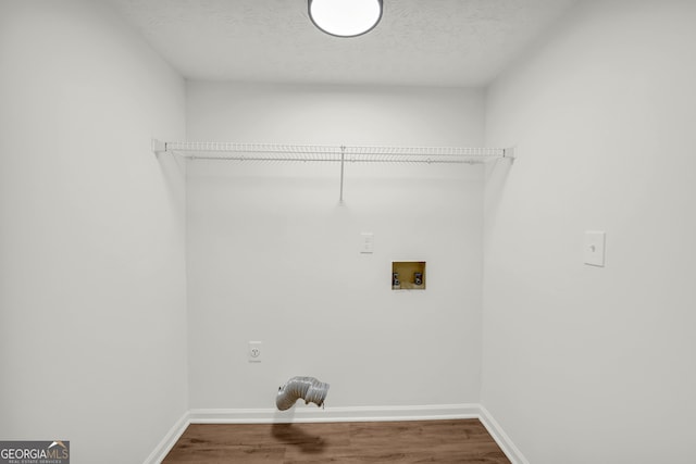 1645 Cobbs Creek Ln, Decatur, GA 30032 - laundry room with electric dryer hookup, washer hookup, wood finished floors, baseboards, and a textured ceiling