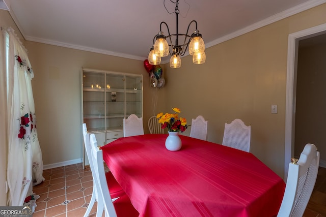 dining space with a chandelier, crown molding, and baseboards