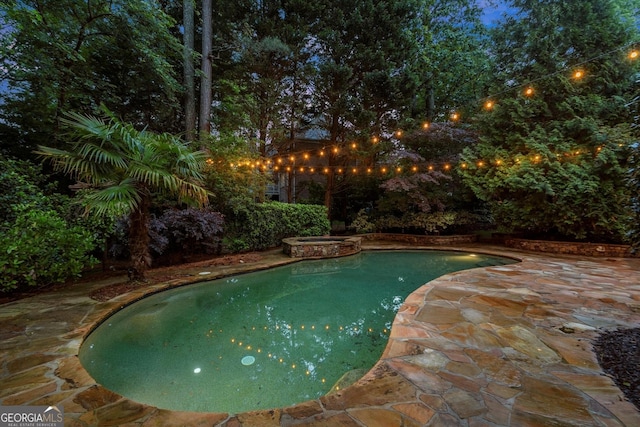 view of pool with a pool with connected hot tub and a patio