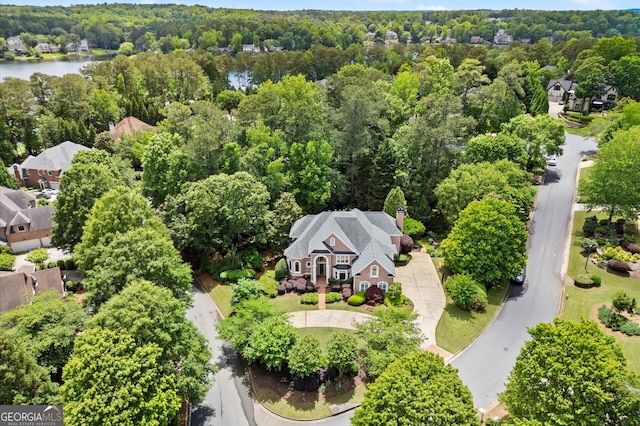 view from above of property featuring a forest and a large body of water