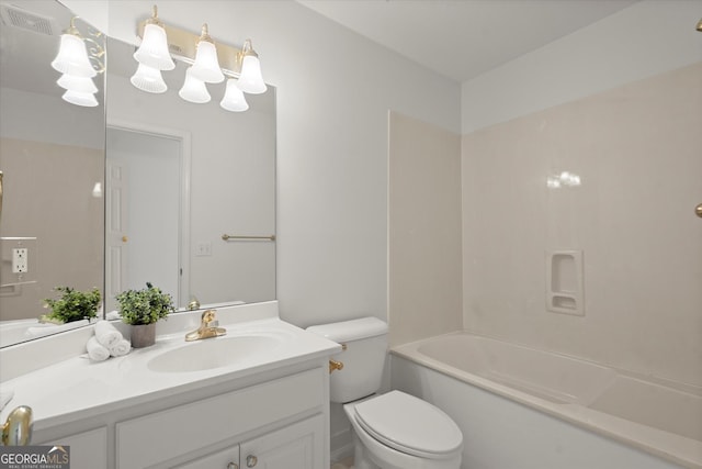 bathroom with toilet, vanity, and washtub / shower combination