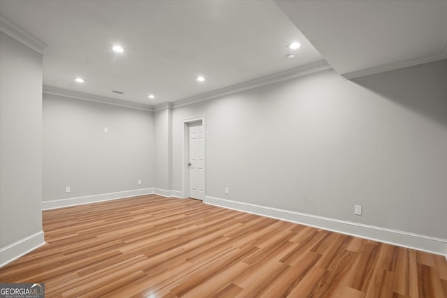 basement with ornamental molding, light wood-style floors, baseboards, and recessed lighting
