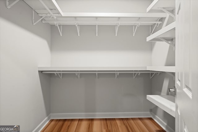 spacious closet with wood finished floors