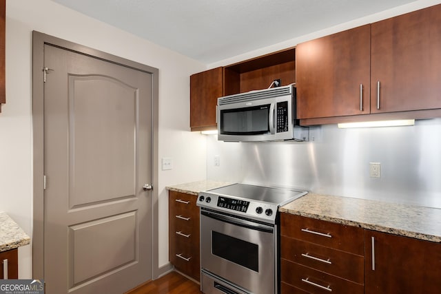 kitchen with stainless steel appliances, open shelves, and dark wood finished floors
